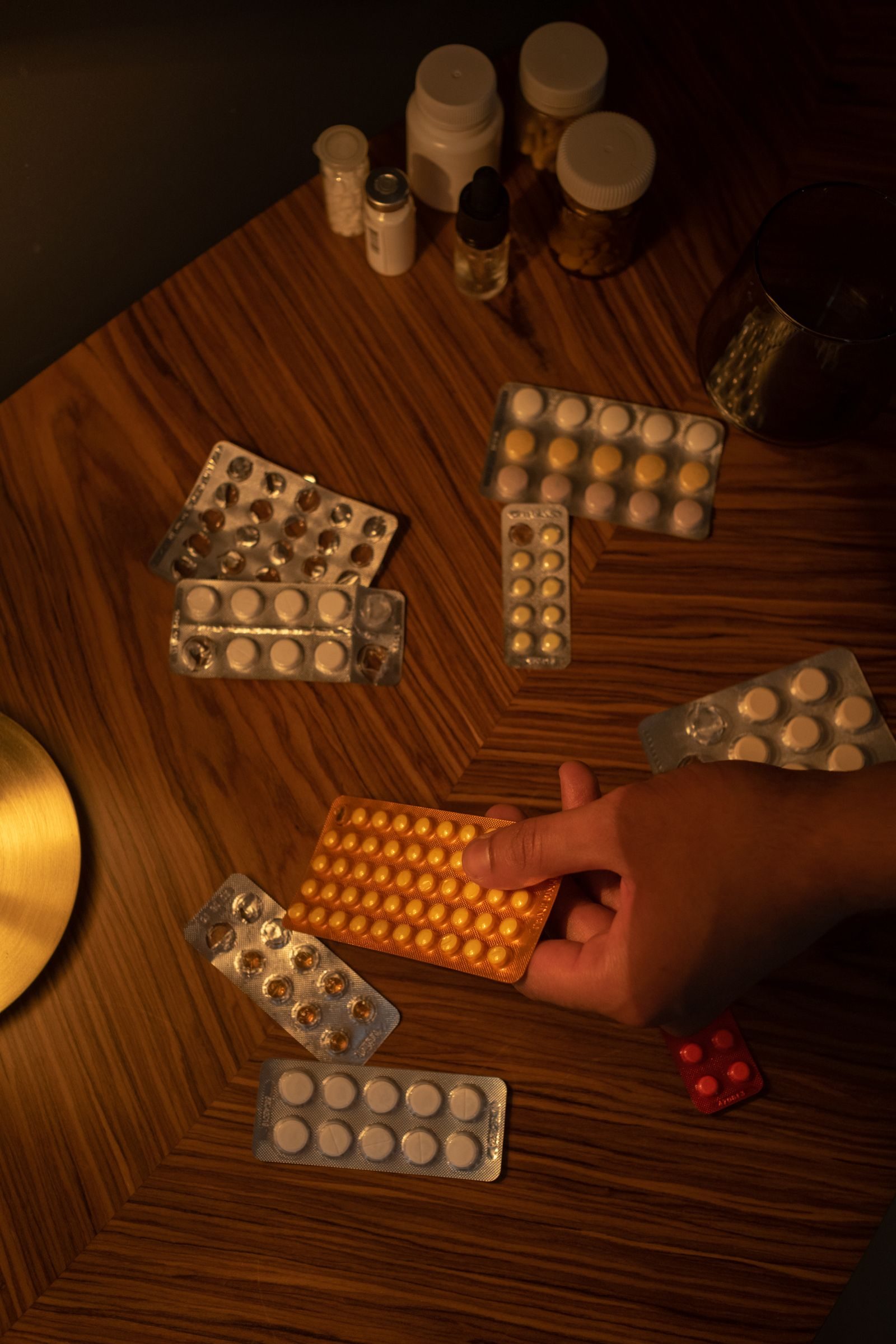 Boxes and blister packs of medication placed on a table