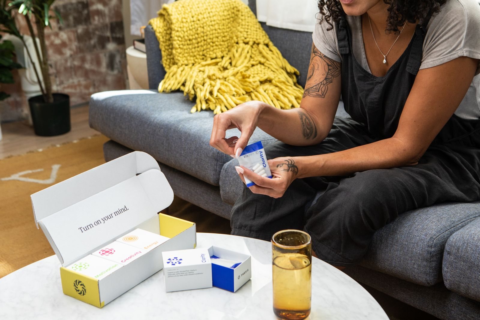 A couple sitting on a sofa, medication boxes on the coffee table
